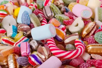 A selection of delightfully sweet treats, including candy canes, to make a sweet grazing board that bit more festive.