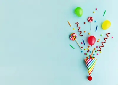 A party hat with streamers and candy