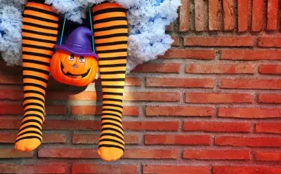 A child in Halloween costume, waiting and ready to go trick or treating!