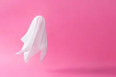 A floating ghost on a bright pink background.