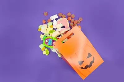 A Halloween Pick n Mix Sweet Gift Box surrounded by Kingsway Dentures, Jelly Pumpkins and Crazy Candy Factory Bone Breaker, all perfect for Halloween!