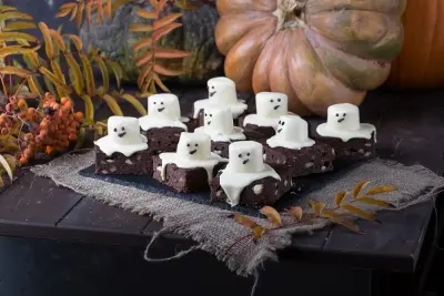 Some tasty chocolate brownies, decorated with mallow ghosts.