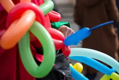 A clown making balloon animals