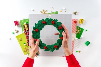 An adorable homemade wreath being made from felt in time for Christmas.