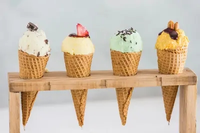 A stand of four ice colourful ice cream cones, with a range of toppings and flavours!